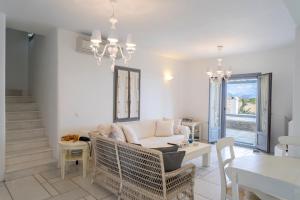 a living room with a couch and a table at Infinity Blue - Villa A in Aspro Chorio Paros