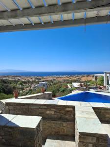 a view from the patio of a villa with a swimming pool at Infinity Blue - Villa A in Aspro Chorio Paros