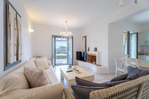 a living room with a couch and a table at Infinity Blue - Villa A in Aspro Chorio Paros