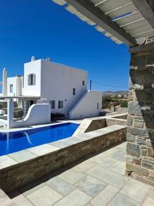 a view of a villa with a swimming pool at Infinity Blue - Villa A in Aspro Chorio Paros