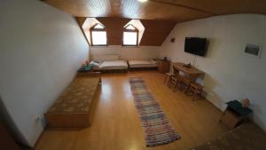an overhead view of a living room with a couch and a tv at Penzion Kokava in Kokava na Rimavica