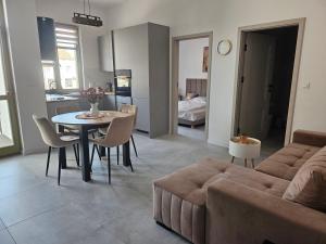 a living room with a couch and a table at Cisza nad Kalwą in Pasym