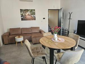 a living room with a table and a couch at Cisza nad Kalwą in Pasym