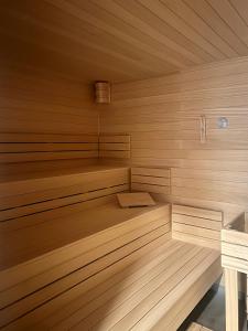a small wooden sauna with wooden benches in it at Aquasolis Spa Hotel in Poľný Kesov +77 photos
