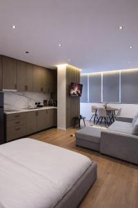 a bedroom with a bed and a kitchen with a table at Hotel Capital Inn Tirana by Arta in Tirana