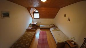 an attic room with two beds and a window at Penzion Kokava in Kokava na Rimavica +30 photos