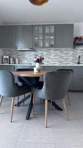a kitchen with a wooden table and two chairs at Villa Nika & Eva Valun in Cres
