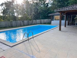 a swimming pool in a yard with a house at Le Clos Périgourdin in Église-Neuve-de-Vergt