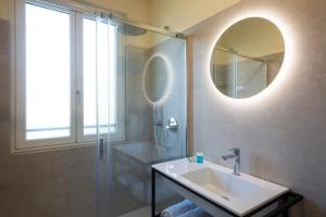 a bathroom with a sink and a shower and a mirror at Villa Viadeipini22 in Bellagio +24 photos