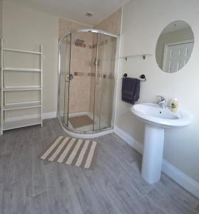 a bathroom with a shower and a sink at Teach Na Dálaigh in Annagry +12 photos