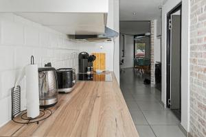 a kitchen with a wooden counter top in a room at Casa Solis at Wild Olive in Windhoek