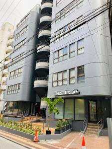 a grey building with a sign that reads conservation headquarters at Hostel Hakuseiso in Naha