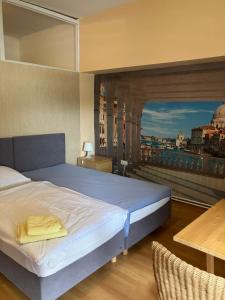 a bedroom with a bed and a view of a city at Apartmentpension Am Krongut in Potsdam