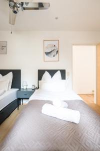 a bedroom with a large bed with white pillows at Spacious 80 m2 Apartment I 3 Rooms I Up to 8 Guests I Near Train Station in Steyr
