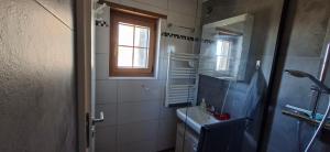 a bathroom with a sink and a mirror and a window at Kiludi in Bullet +10 photos
