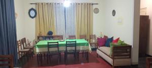 a dining room with a table and chairs and a couch at Lighthouse Peacock Villa in Dondra West