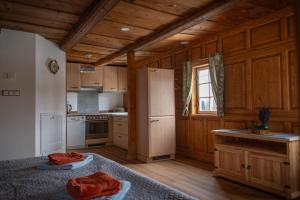 a kitchen with wooden cabinets and a white refrigerator at Ferienhaus Sonne in Jiříkov