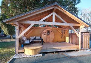a wooden gazebo with a table and a bench at Ferienhaus Sonne in Jiříkov