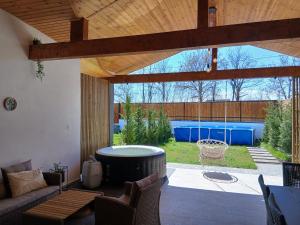 a patio with a hot tub in a yard at Popa Cabana in Sibiu