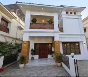 a house with a front entrance with potted plants at Rudra BNBF in Gandhidham