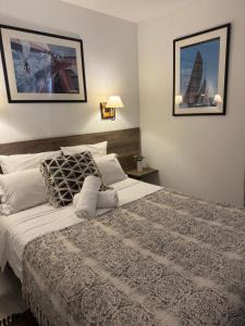 a bedroom with a large bed and two pictures on the wall at Antibes Port - Terrasse - Parking - Piscine in Antibes +25 photos