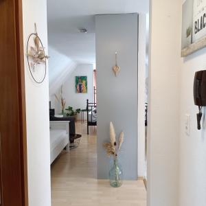 a hallway with a vase of flowers in a room at Urban Apple in Bad Mergentheim