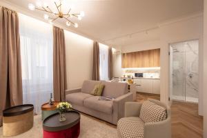 a living room with a couch and chairs and a table at Central Suites in Lugano