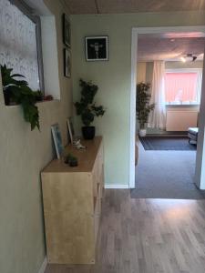 a living room with a dresser and a hallway at 70 m2 Anneks på gården in Malling