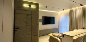 a living room with a sliding glass door in a room at Apartaments Jaunyste Free parking, Self Check - in in Klaipėda