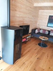 a living room with a refrigerator and a couch at Ferienhaus Summerwiese in Ochsenhausen