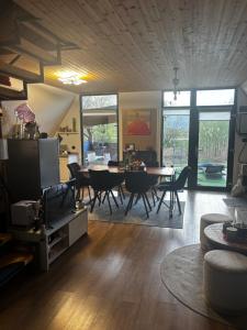 a living room with a tv and a table and chairs at LAKEVIEW A-frame ESCAPE in Tisa +30 photos