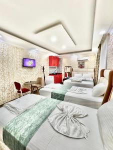 a hotel room with three beds and a kitchen at Sultanahmet Lİfe Apart in Istanbul