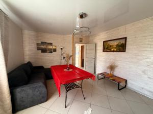 a living room with a couch and a red table at Igor House in Jūrmala