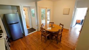 a dining room with a table and a refrigerator at Home in Newtown in Toowoomba