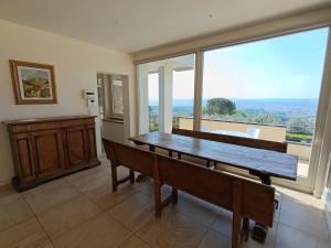 a dining room with a table and a large window at Appartamento con piscina in Villa in Florence
