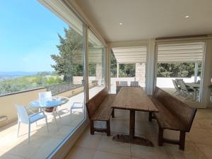 a dining room with a table and chairs and glass windows at Appartamento con piscina in Villa in Florence +18 photos