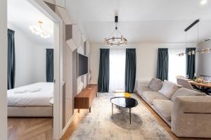 a living room with a couch and a bed at Central Suites in Lugano