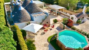 an aerial view of a house with a swimming pool at Trulli Fenice in Martina Franca