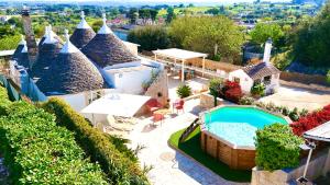 an aerial view of a villa with a swimming pool at Trulli Fenice in Martina Franca