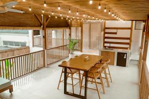 a kitchen with a wooden table and chairs on a balcony at Casa Solisa in Kerobokan