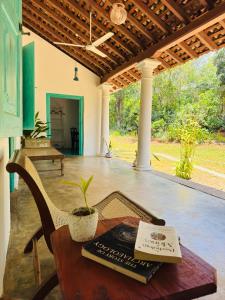 a table with a book and a plant on a porch at Villa Ceylora in Busse