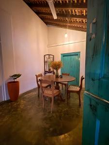 a dining room with a wooden table and chairs at Villa Ceylora in Busse