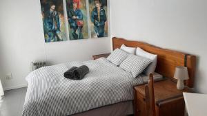 a bedroom with a bed with a hat on it at Pearly Beach House in Plettenberg Bay +17 photos