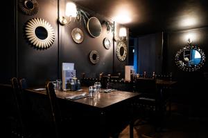 a dining room with a table and mirrors on the wall at The Kings Head Rye in Rye