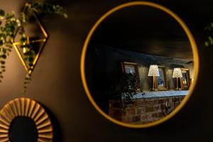 a mirror reflection of a room with a fireplace at The Kings Head Rye in Rye