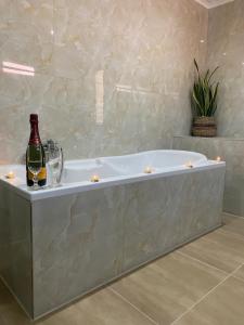 a bath tub with a bottle of wine on it at Harmony Home in Kouspádes