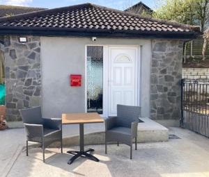 a table and chairs in front of a building at MeadowView Apt B -2 mins walk Carrigaline town -sleeps 4 - 2 Adults and 2 Kids in Carrigaline