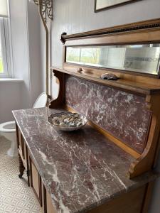 a kitchen with a marble counter top with a bowl on it at Trevanger Farm Bed and Breakfast in Wadebridge +26 photos