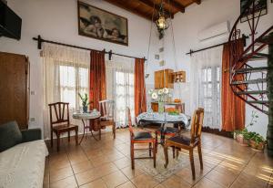 a living room with a table and chairs and a couch at Ifigenia Lux MAISONETTE in oldtown and Villas in theriso vilage 14 km outside of chania in Chania