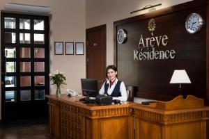 a woman sitting at a desk in an office at Arève Résidence Boutique Hotel in Yerevan